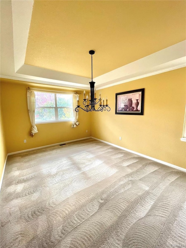 16866 E Peakview Ave, Aurora, CO 80016 - spare room featuring a tray ceiling, carpet flooring, and a chandelier