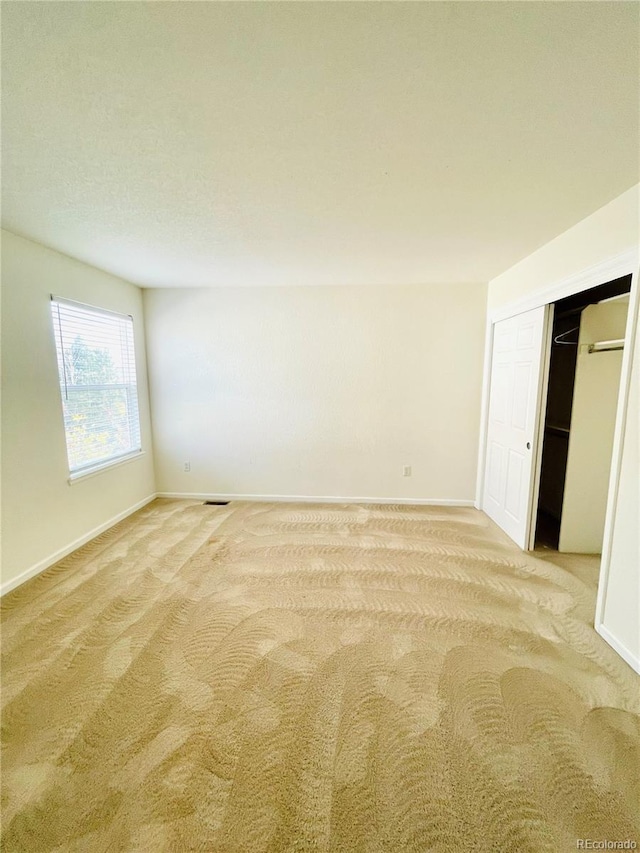 16866 E Peakview Ave, Aurora, CO 80016 - unfurnished bedroom featuring light colored carpet and a closet