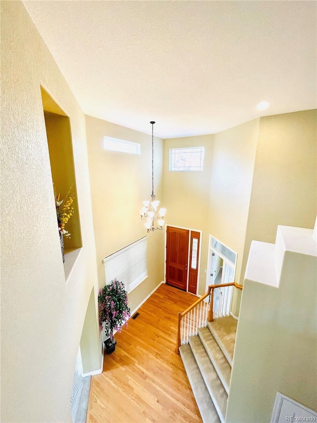 16866 E Peakview Ave, Aurora, CO 80016 - foyer featuring a chandelier, wood finished floors, and stairway