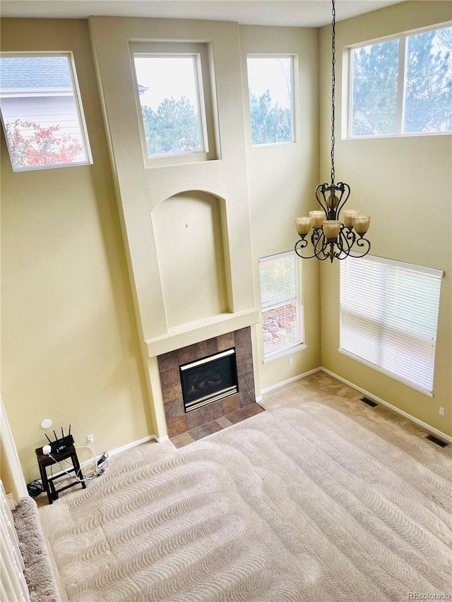 16866 E Peakview Ave, Aurora, CO 80016 - unfurnished living room with carpet floors, a chandelier, and a fireplace