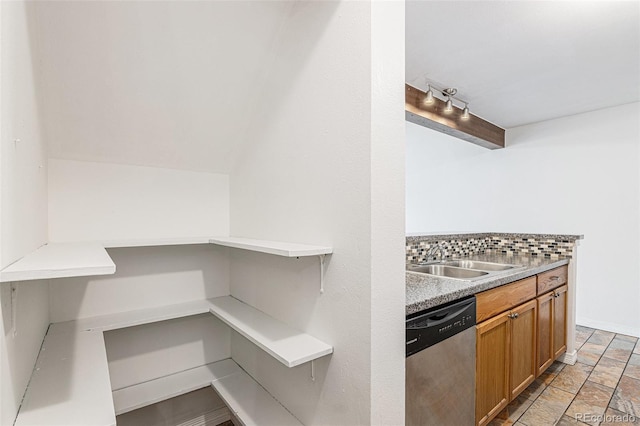 kitchen with dishwasher, a sink, decorative backsplash, light countertops, and beam ceiling