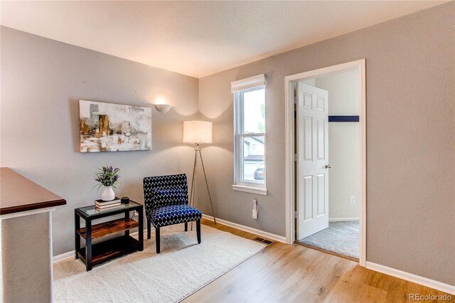sitting room with wood finished floors and baseboards