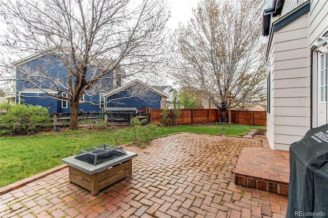 view of patio featuring a fire pit and a grill