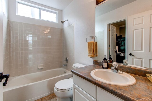 bathroom featuring toilet, bathtub / shower combination, and vanity