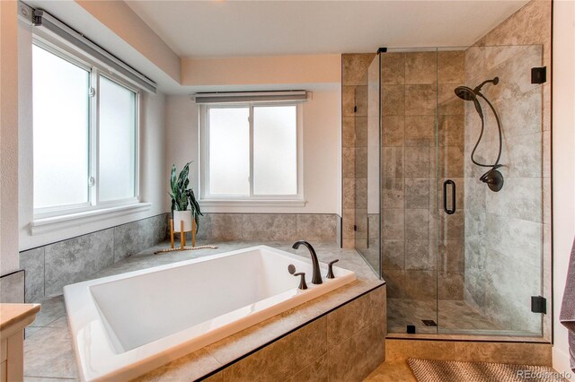 full bath featuring a stall shower and a bath