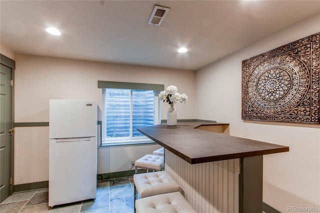 dining space with baseboards, recessed lighting, and wainscoting