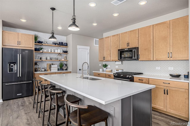 4522 Barrow Ln, Timnath, CO 80547 - kitchen with high quality fridge, gas range, black microwave, a sink, and light wood-style flooring