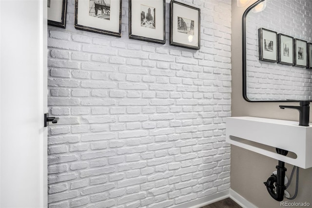 4522 Barrow Ln, Timnath, CO 80547 - bathroom with brick wall and wood finished floors