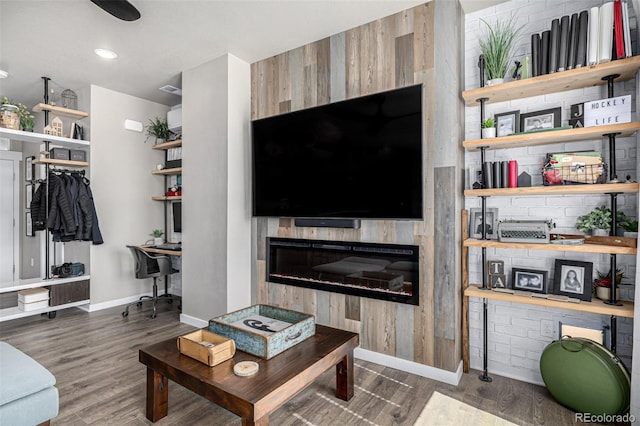 4522 Barrow Ln, Timnath, CO 80547 - living area with baseboards, wood finished floors, and a glass covered fireplace