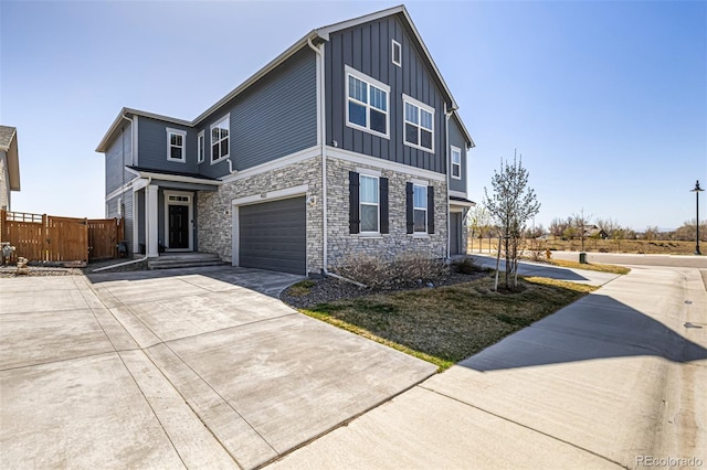 4522 Barrow Ln, Timnath, CO 80547 - view of front of property featuring board and batten siding, a garage, concrete driveway, and stone siding