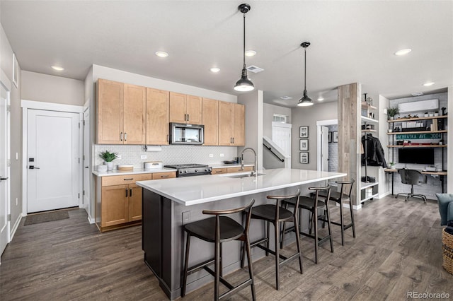 4522 Barrow Ln, Timnath, CO 80547 - kitchen featuring stainless steel microwave, a sink, stove, dark wood finished floors, and a desk