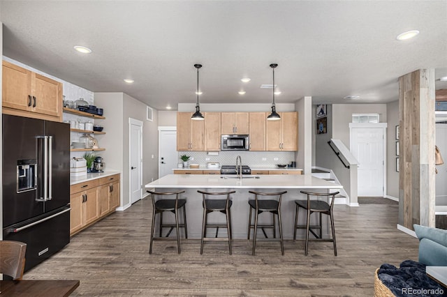 4522 Barrow Ln, Timnath, CO 80547 - kitchen with high quality fridge, stainless steel microwave, dark wood-type flooring, tasteful backsplash, and light countertops