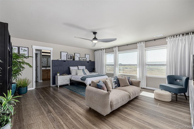 4522 Barrow Ln, Timnath, CO 80547 - bedroom featuring wood finished floors, baseboards, a ceiling fan, and connected bathroom