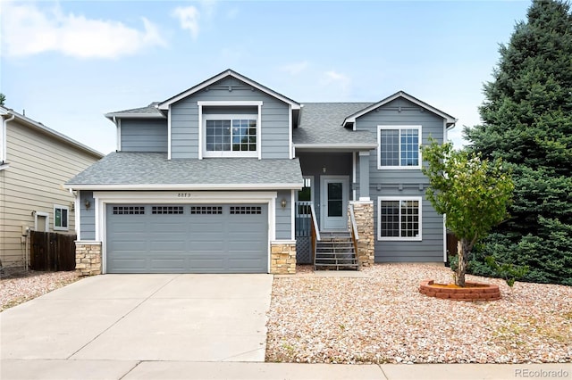 8879 Apache Plume Dr, Parker, CO 80134 - view of front facade featuring roof with shingles, concrete driveway, stone siding, and a garage