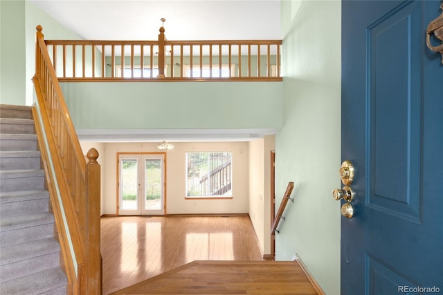 8879 Apache Plume Dr, Parker, CO 80134 - foyer featuring wood finished floors, french doors, a high ceiling, baseboards, and stairway