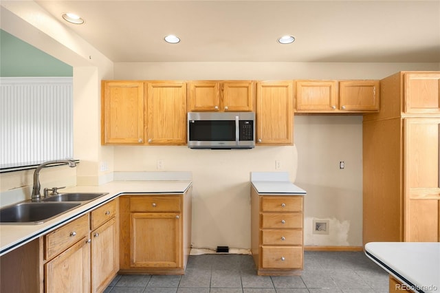 8879 Apache Plume Dr, Parker, CO 80134 - kitchen featuring stainless steel microwave, a sink, recessed lighting, light tile patterned flooring, and light countertops
