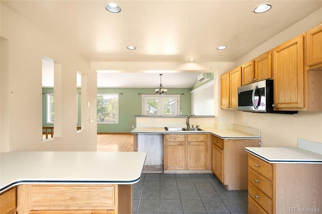 8879 Apache Plume Dr, Parker, CO 80134 - kitchen featuring a peninsula, recessed lighting, light countertops, a sink, and stainless steel microwave