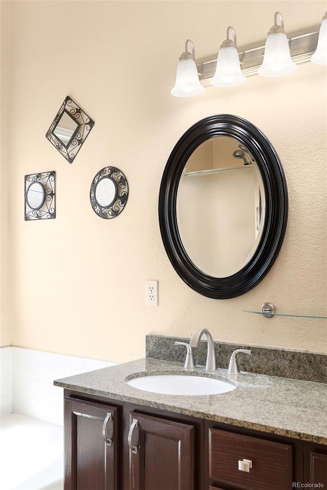 8879 Apache Plume Dr, Parker, CO 80134 - bathroom featuring vanity and a garden tub
