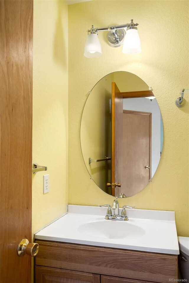 8879 Apache Plume Dr, Parker, CO 80134 - half bath featuring vanity and toilet