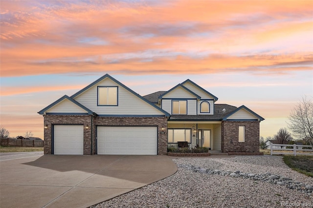 16665 Kenuil St, Brighton, CO 80603 - view of front facade with driveway, a porch, brick siding, and an attached garage