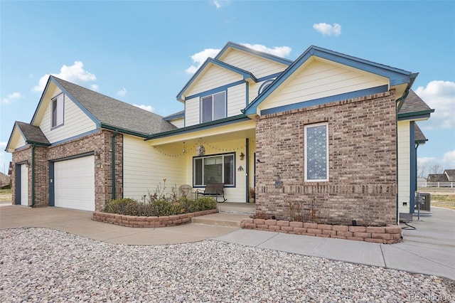 16665 Kenuil St, Brighton, CO 80603 - view of front of house featuring covered porch, brick siding, concrete driveway, and a garage