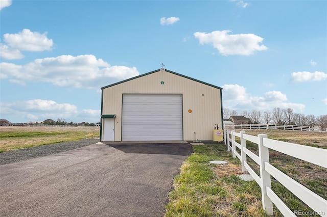 16665 Kenuil St, Brighton, CO 80603 - detached garage featuring driveway and a view of rural / pastoral area
