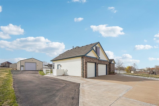 16665 Kenuil St, Brighton, CO 80603 - view of home's exterior with brick siding and a detached garage