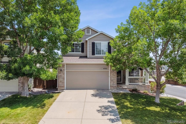 traditional-style home featuring brick siding, an attached garage, driveway, and a front yard