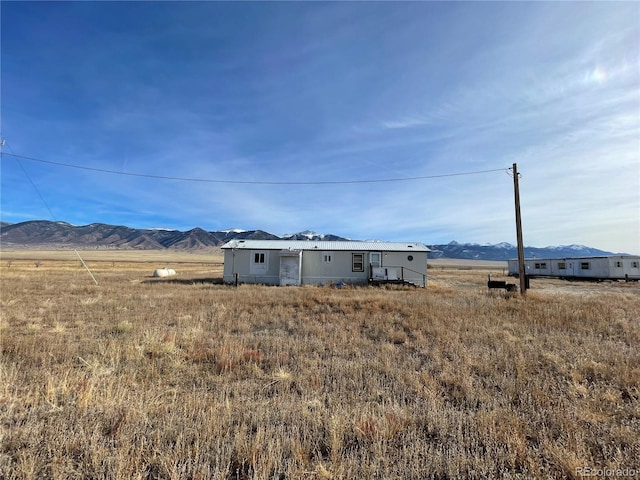 view of yard with a mountain view and a rural view