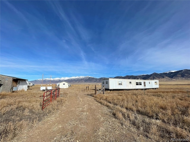 view of yard featuring a mountain view and a rural view