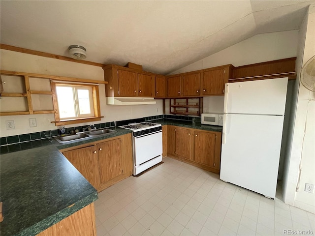 kitchen featuring lofted ceiling, sink, and white appliances