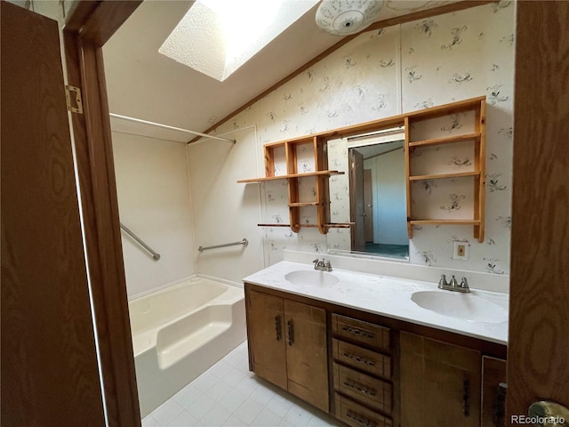 bathroom with shower / bathing tub combination, vanity, lofted ceiling with skylight, and tile patterned flooring