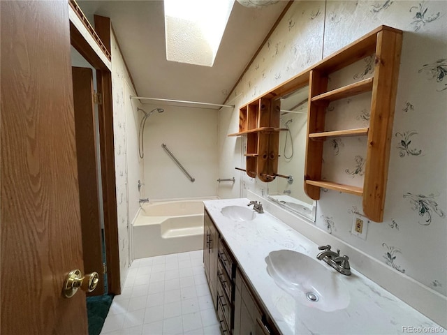 bathroom featuring bathtub / shower combination, vanity, and lofted ceiling with skylight