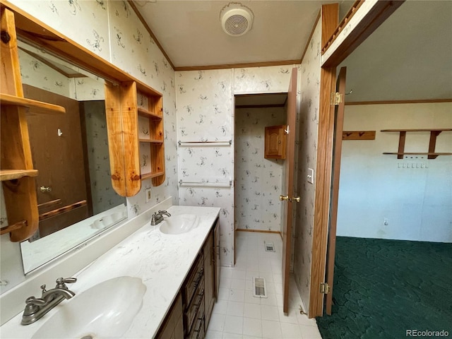 bathroom with tile patterned floors, crown molding, and vanity