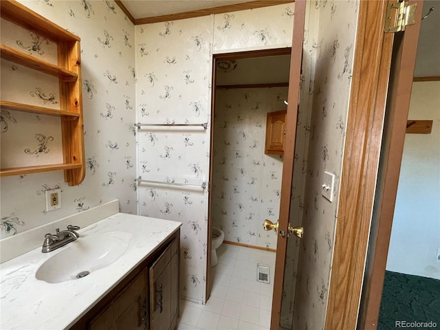 bathroom featuring toilet, vanity, tile patterned floors, and ornamental molding