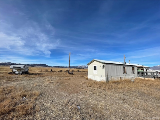 view of home's exterior with a mountain view and a rural view