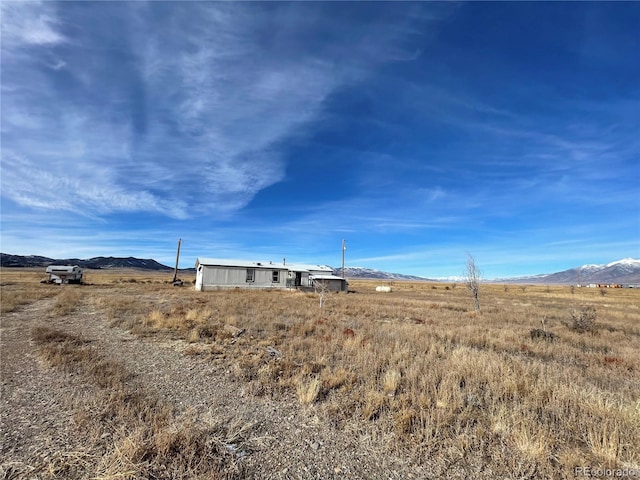 view of yard featuring a mountain view and a rural view