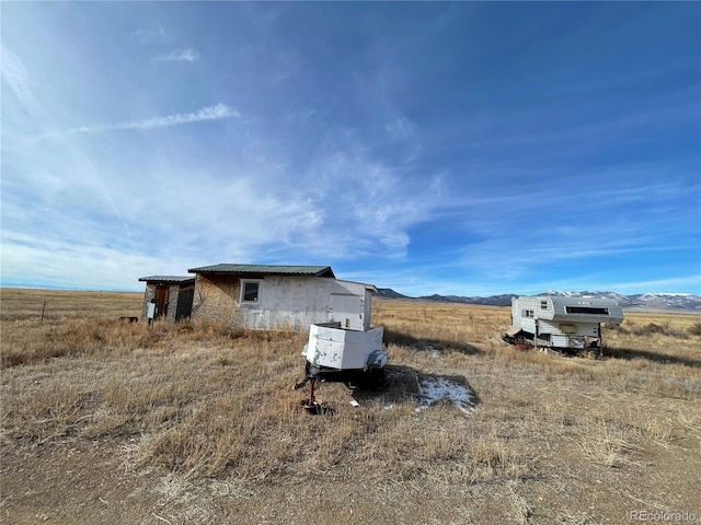 view of side of home featuring a rural view