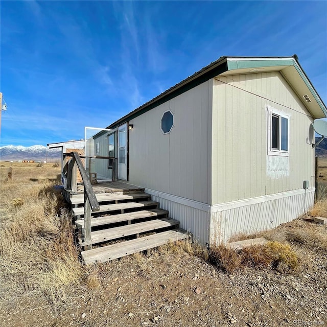 view of home's exterior with a wooden deck