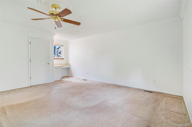 72 S Nome St, Aurora, CO 80012 - empty room featuring ornamental molding, a ceiling fan, and light colored carpet