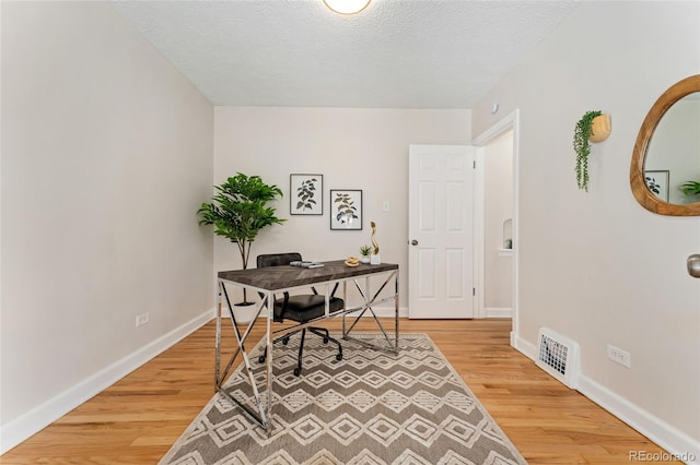 1691 Roslyn St, Denver, CO 80220 - office featuring light wood-style flooring, baseboards, and a textured ceiling