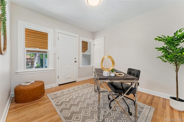 1691 Roslyn St, Denver, CO 80220 - home office featuring baseboards, wood finished floors, and a textured ceiling