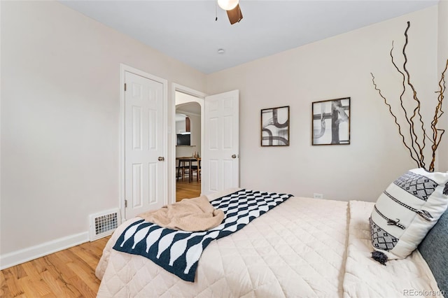 1691 Roslyn St, Denver, CO 80220 - bedroom with arched walkways, wood finished floors, baseboards, and a ceiling fan