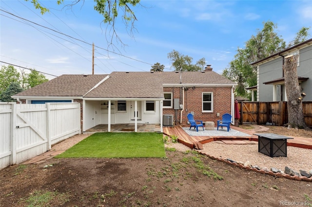 1691 Roslyn St, Denver, CO 80220 - back of property featuring an outdoor fire pit, a gate, a fenced backyard, a deck, and a shingled roof