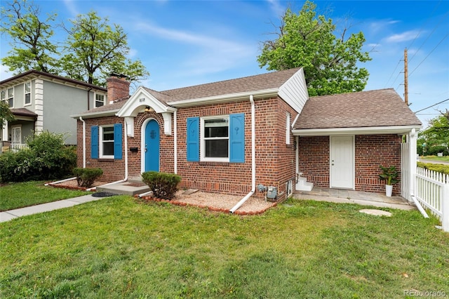 1691 Roslyn St, Denver, CO 80220 - view of front facade featuring brick siding, a chimney, and a shingled roof