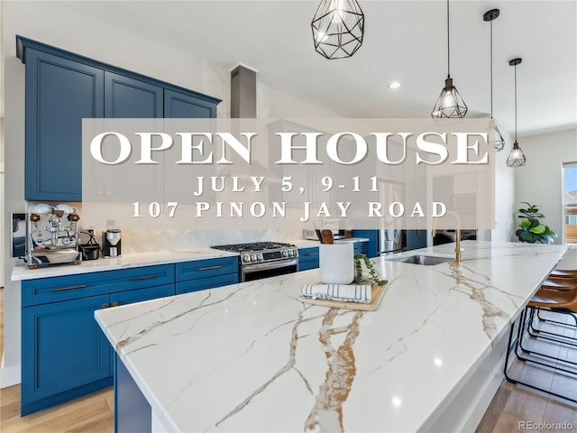 107 Pinon Jay Rd, Buena Vista, CO 81211 - kitchen with gas stove, blue cabinets, a breakfast bar, light wood-style flooring, and recessed lighting