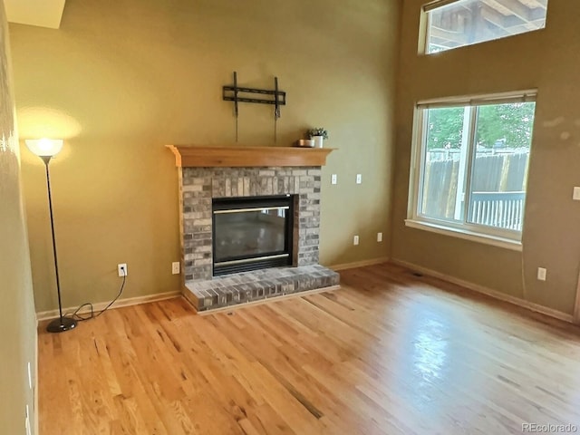 13313 Elizabeth St, Thornton, CO 80241 - unfurnished living room with wood finished floors and a glass covered fireplace