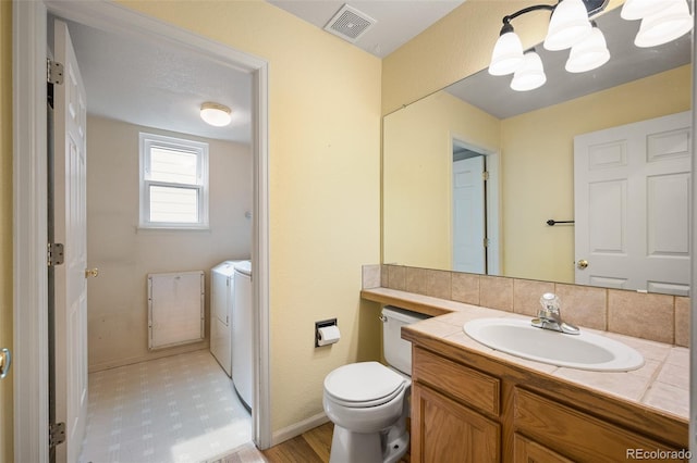 13313 Elizabeth St, Thornton, CO 80241 - bathroom with washing machine and clothes dryer and vanity