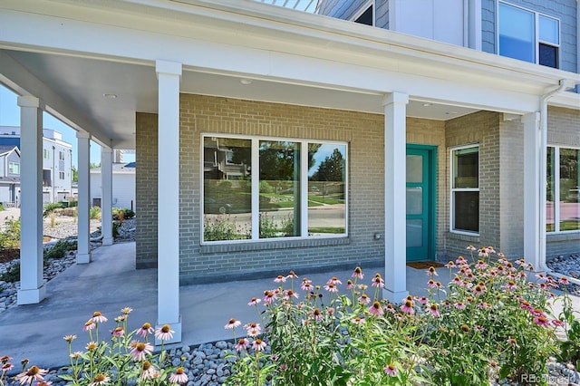 888 S Valentia St Unit 20-101, Denver, CO 80247 - entrance to property featuring brick siding and covered porch