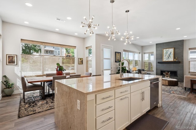 888 S Valentia St Unit 20-101, Denver, CO 80247 - kitchen featuring a chandelier, wood finished floors, light stone counters, recessed lighting, and healthy amount of natural light